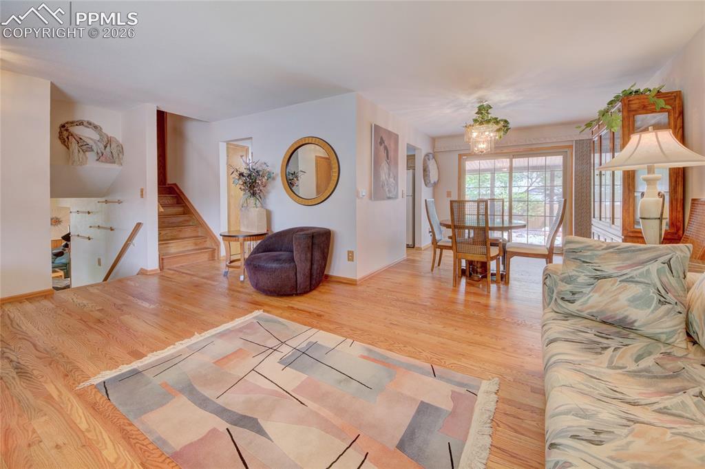 Image 3 of 33: Open-concept living space featuring wood-finish flooring, a dining area wit