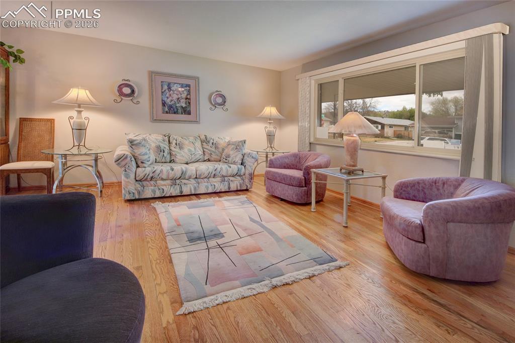 Image 4 of 33: Hardwood-style flooring throughout this living area