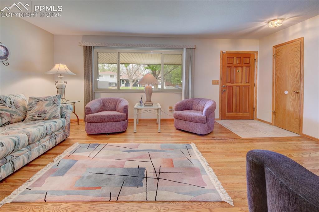 Image 6 of 33: Hardwood flooring complements a light-toned wall finish