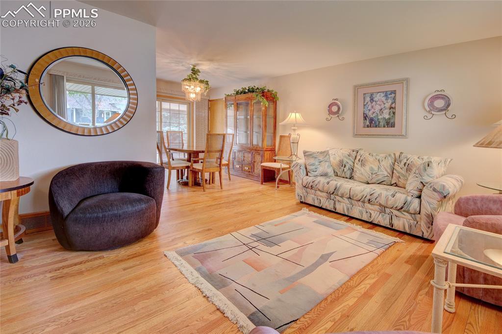 Image 8 of 33: Hardwood flooring throughout the open living and dining areas