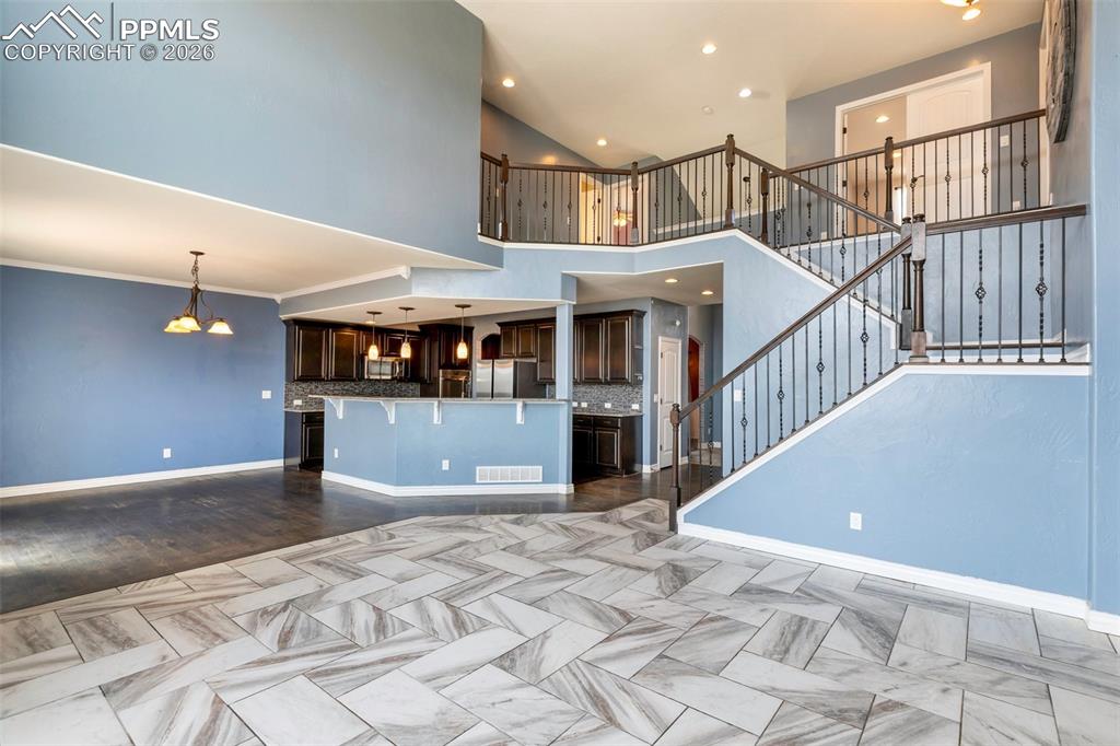 Image 7 of 45: Open main level with striking staircase