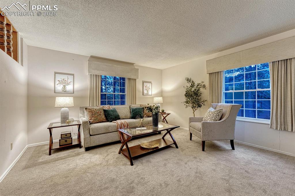 Image 10 of 50: Large windows in the formal Living Room provide tons of natural light throu