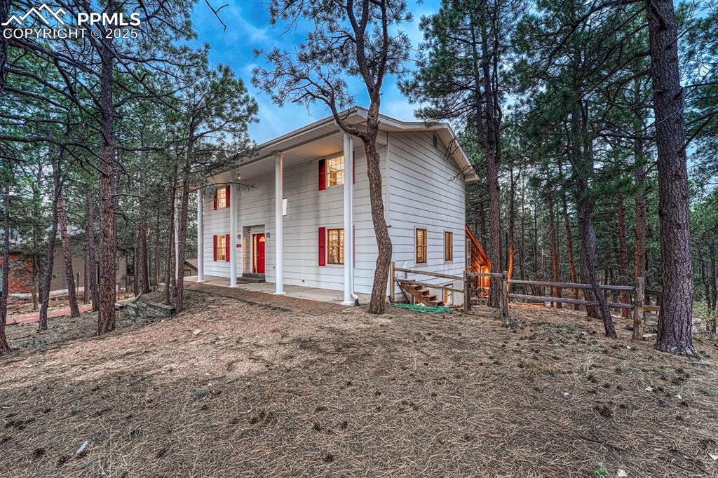 Image 2 of 50: Set on a 0.64-acre peaceful, wooded lot.