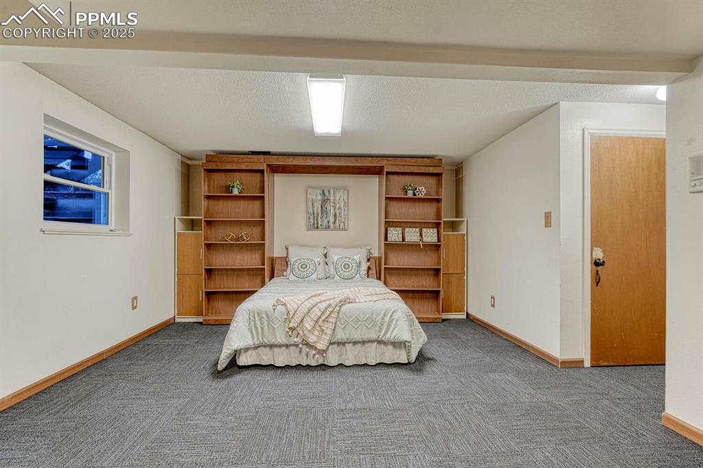 Image 38 of 50: Comfortable built-in murphy bed with built-in bookshelves.