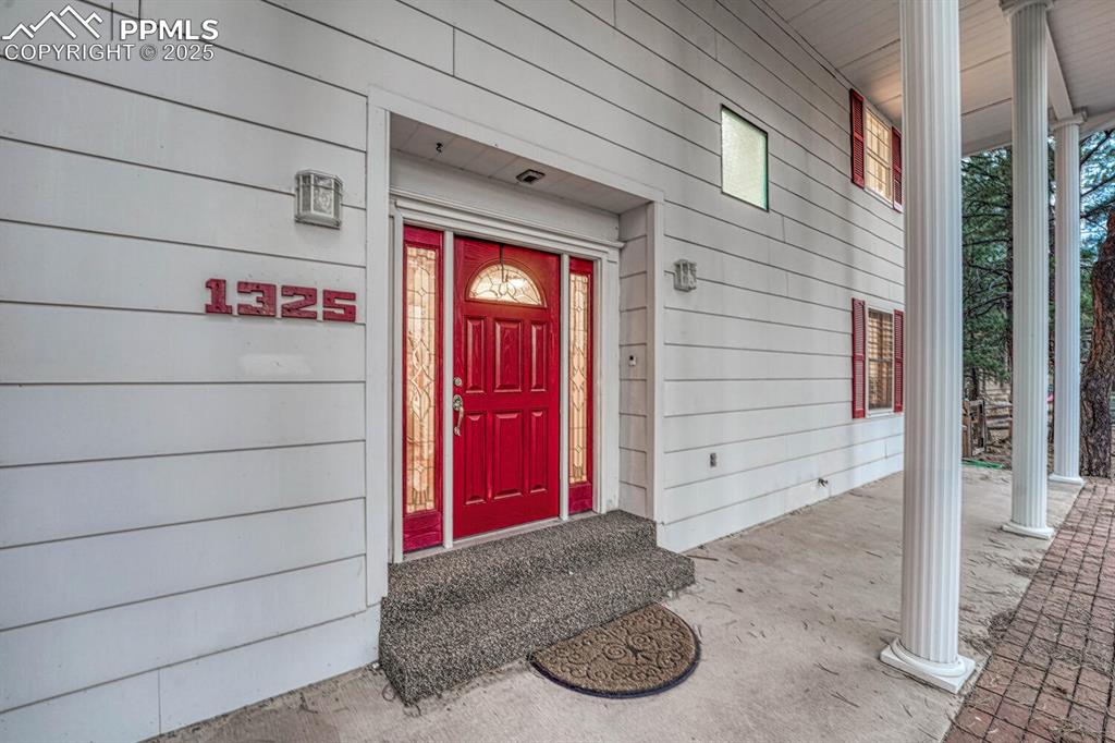 Image 6 of 50: Covered front porch to enjoy your morning coffee and soak in the Colorado s