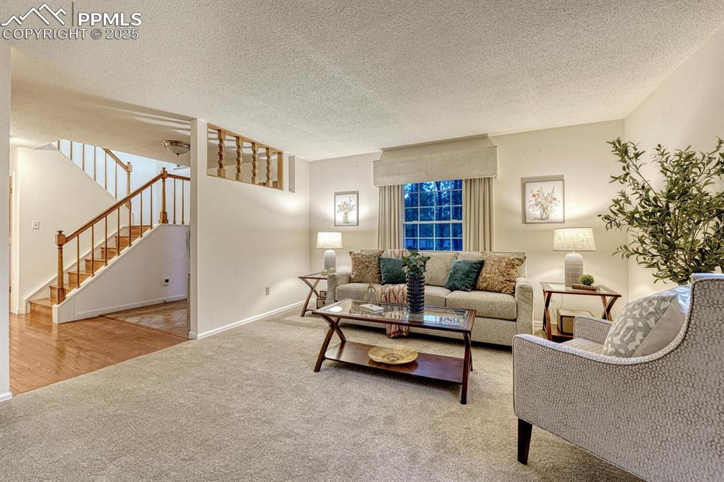 Image 9 of 50: Formal Living Room with neutral carpet and window with front yard views.