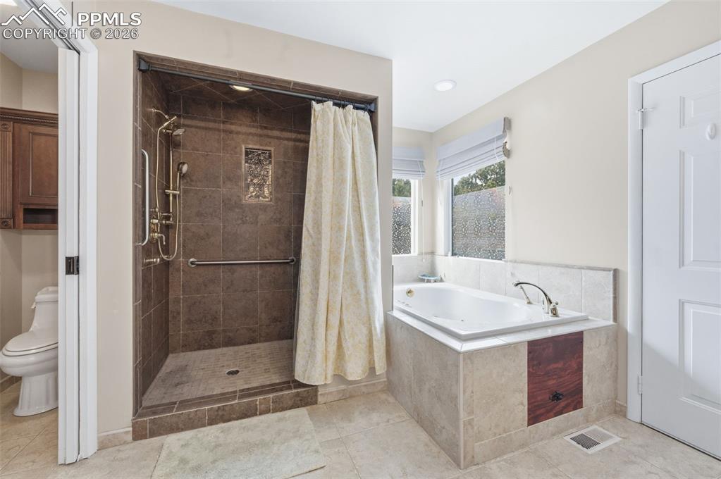 Image 21 of 50: Primary 5 piece bath with a walk out to the back patio