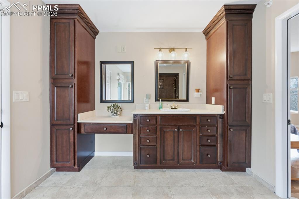 Image 22 of 50: Vanity in the primary bath