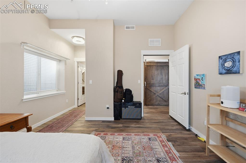 Image 43 of 50: Bedroom #8 with private half bath on the left and entrance to the hall on t