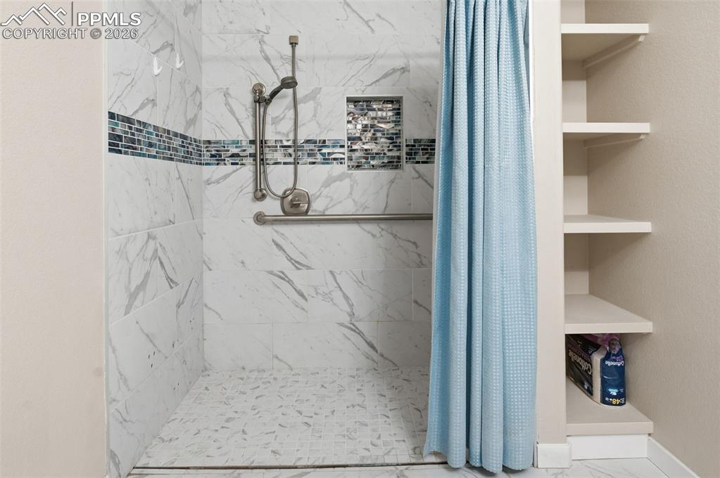 Image 45 of 50: Shower in 3/4 hall bath lower level