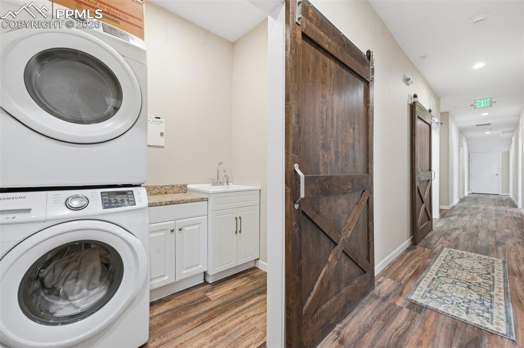 Image 47 of 50: Laundry room with soaking tub on the lower level