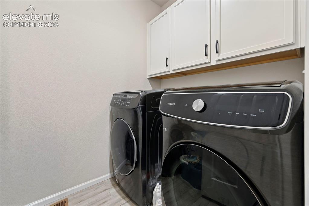 Image 21 of 31: Built-in white cabinetry with black hardware