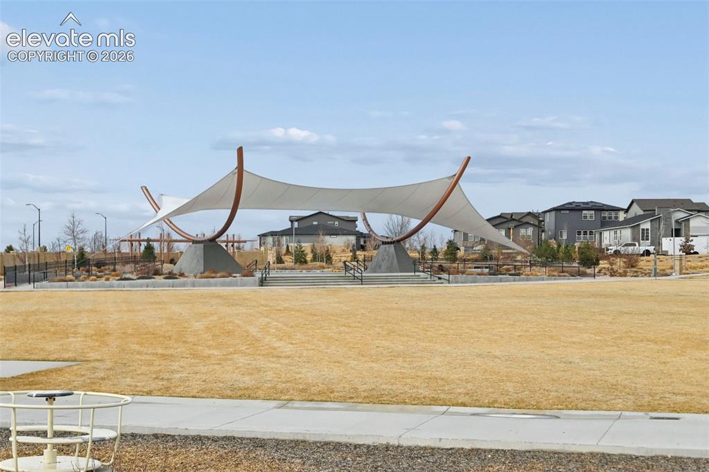 Image 26 of 31: Expansive open space featuring a contemporary shade structure with concrete