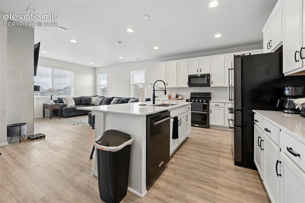 Image 5 of 31: Open-concept living space with wood-finish flooring