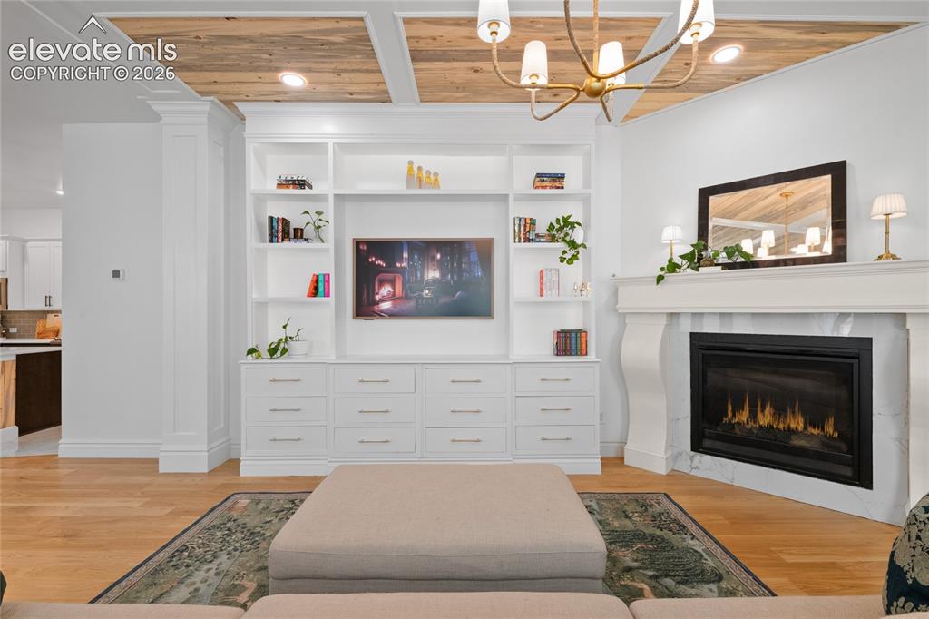 Image 10 of 45: Spacious living area with built-ins and gas fireplace
