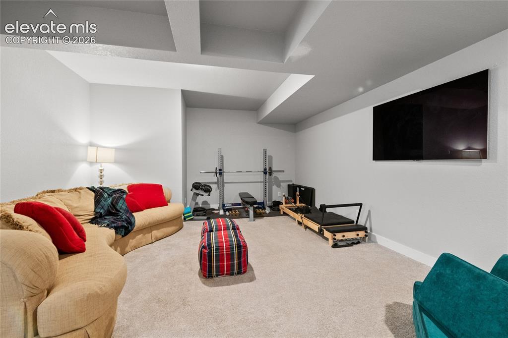 Image 35 of 45: Basement TV Room, Plumbed for Wet Bar