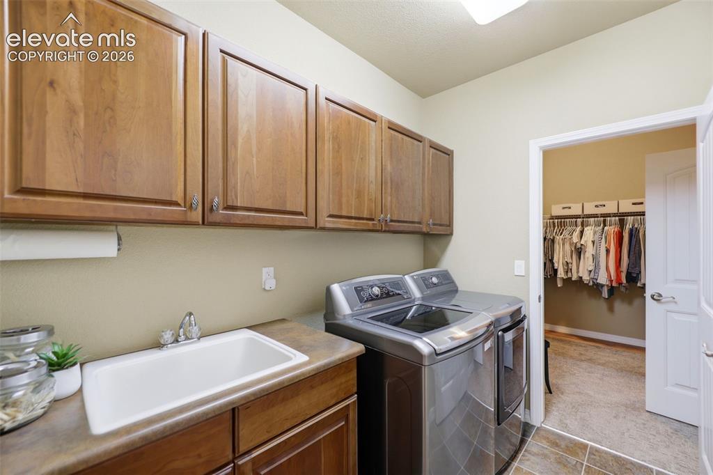 Image 26 of 48: A large laundry space on the main level, just off the primary bedroom! 
