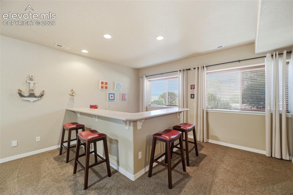 Image 30 of 48: The basement also has a wet bar and plenty of space to have fun gatherings!