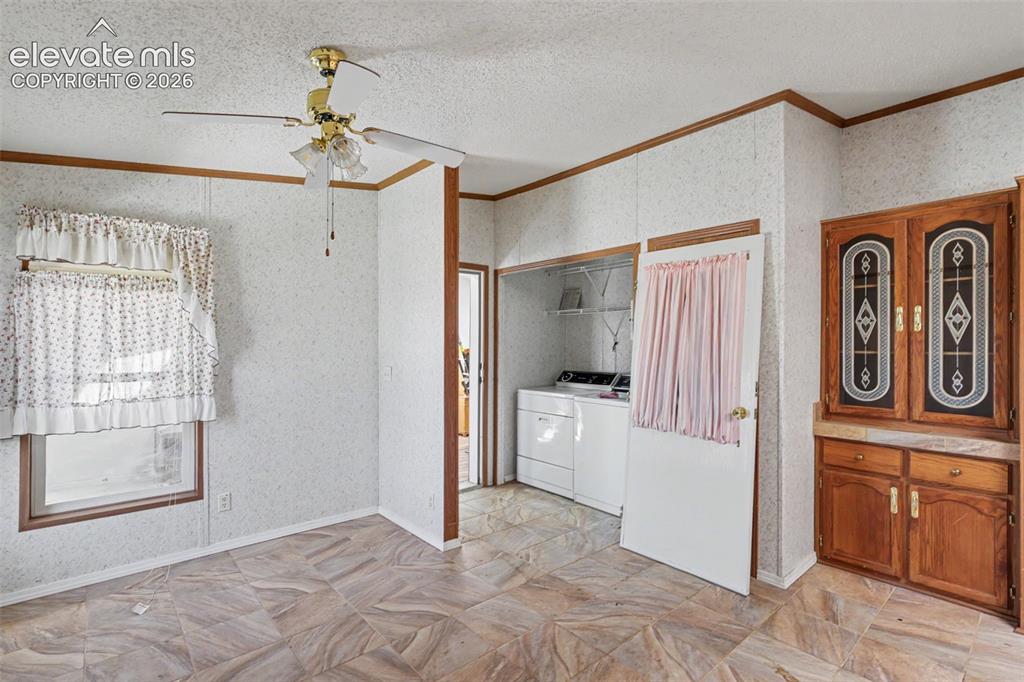 Image 12 of 26: Interior space featuring patterned floor tile and a ceiling fan with integr