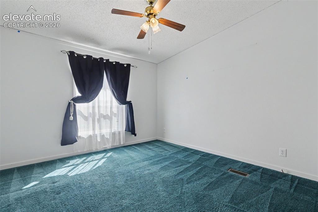 Image 18 of 26: Room featuring wall-to-wall carpeting, white painted walls, and a window wi