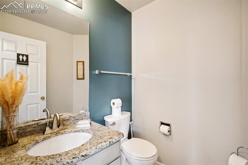 Image 10 of 28: Half bathroom with toilet and vanity