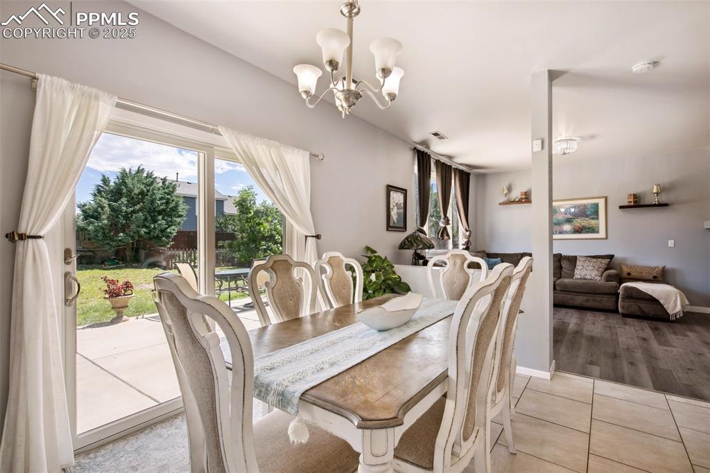 Image 16 of 28: Dining space with plenty of natural light, light tile patterned floors, and
