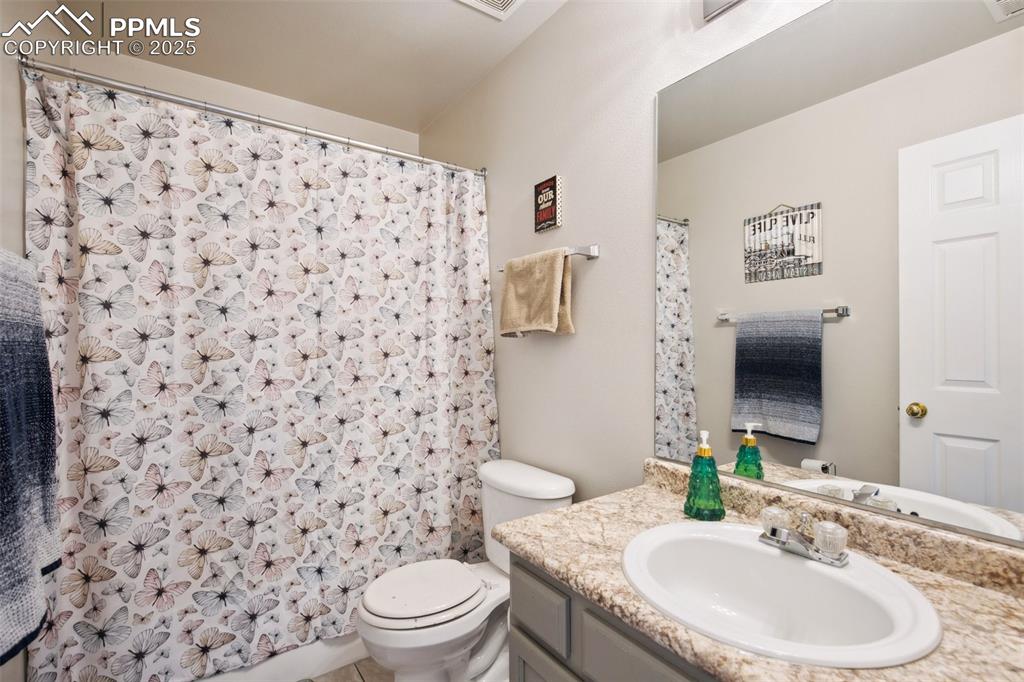 Image 20 of 28: Bathroom featuring vanity and curtained shower