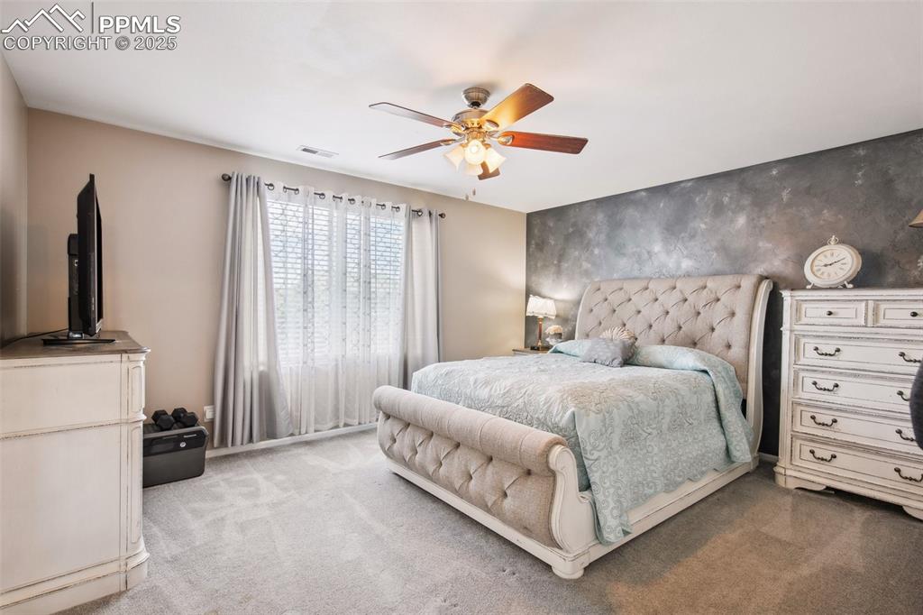 Image 23 of 28: Bedroom featuring carpet flooring and ceiling fan