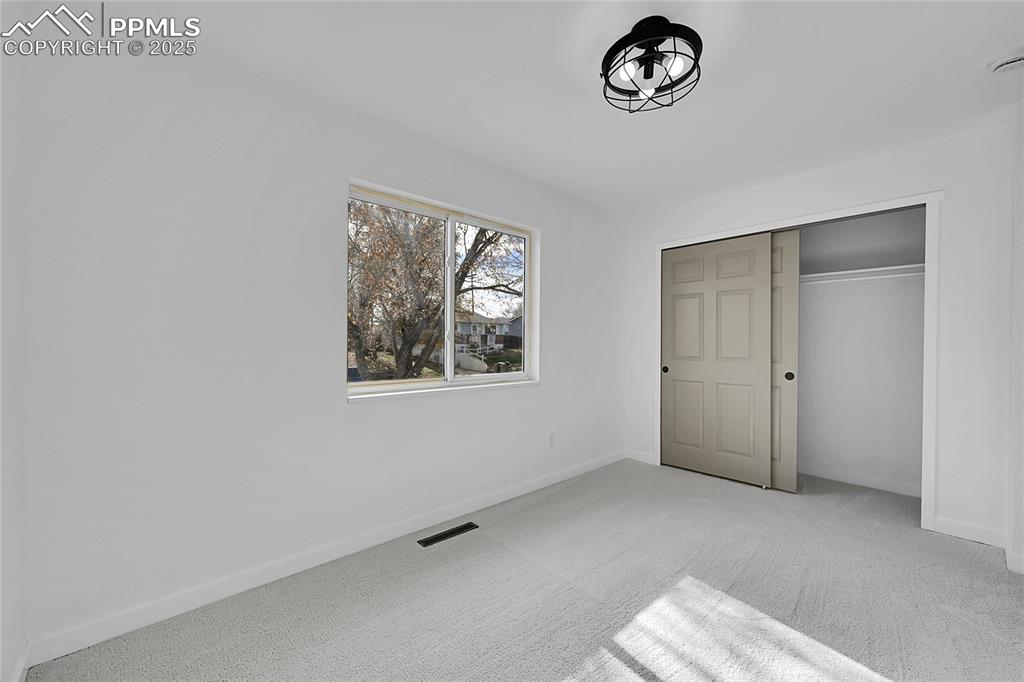 Image 14 of 29: Unfurnished bedroom with carpet floors and a closet