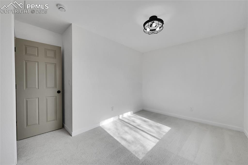 Image 15 of 29: Spare room featuring light colored carpet and baseboards
