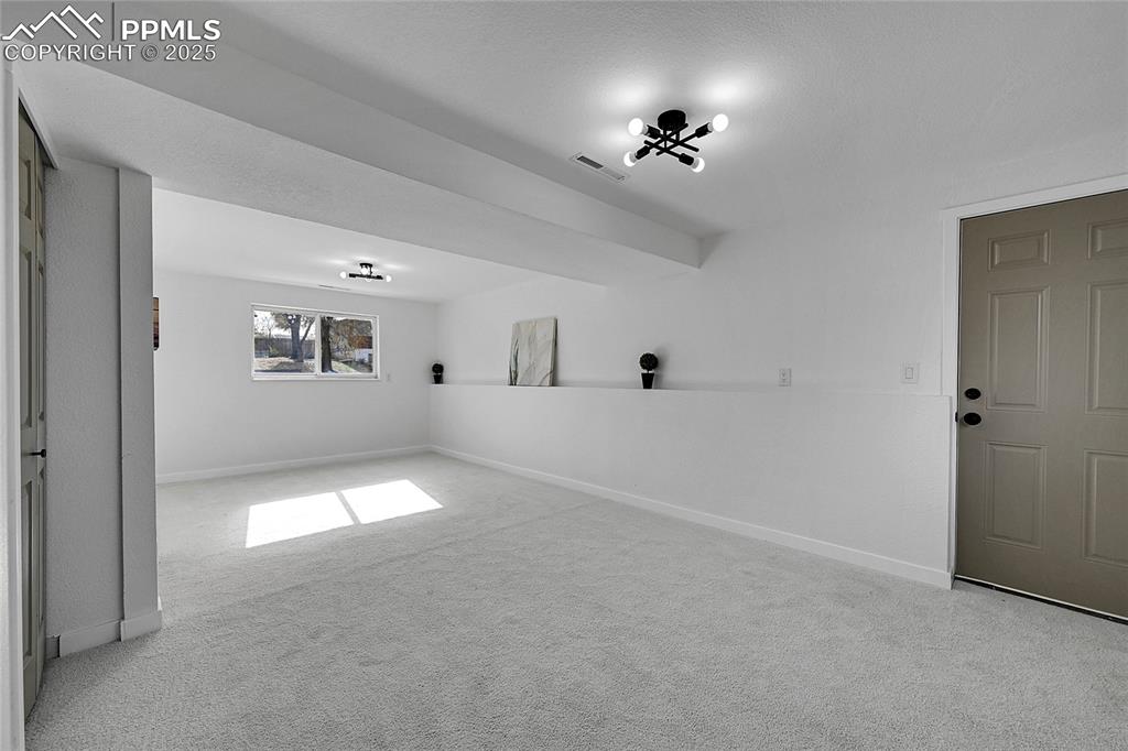Image 19 of 29: Unfurnished room with light carpet and baseboards