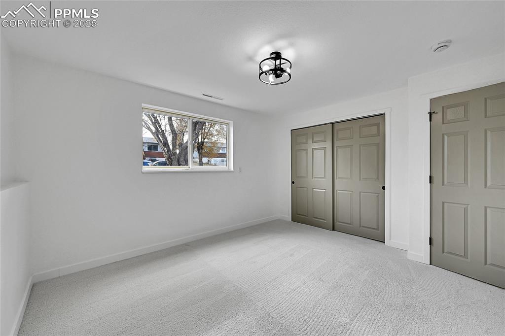 Image 21 of 29: Unfurnished bedroom with carpet floors and a closet