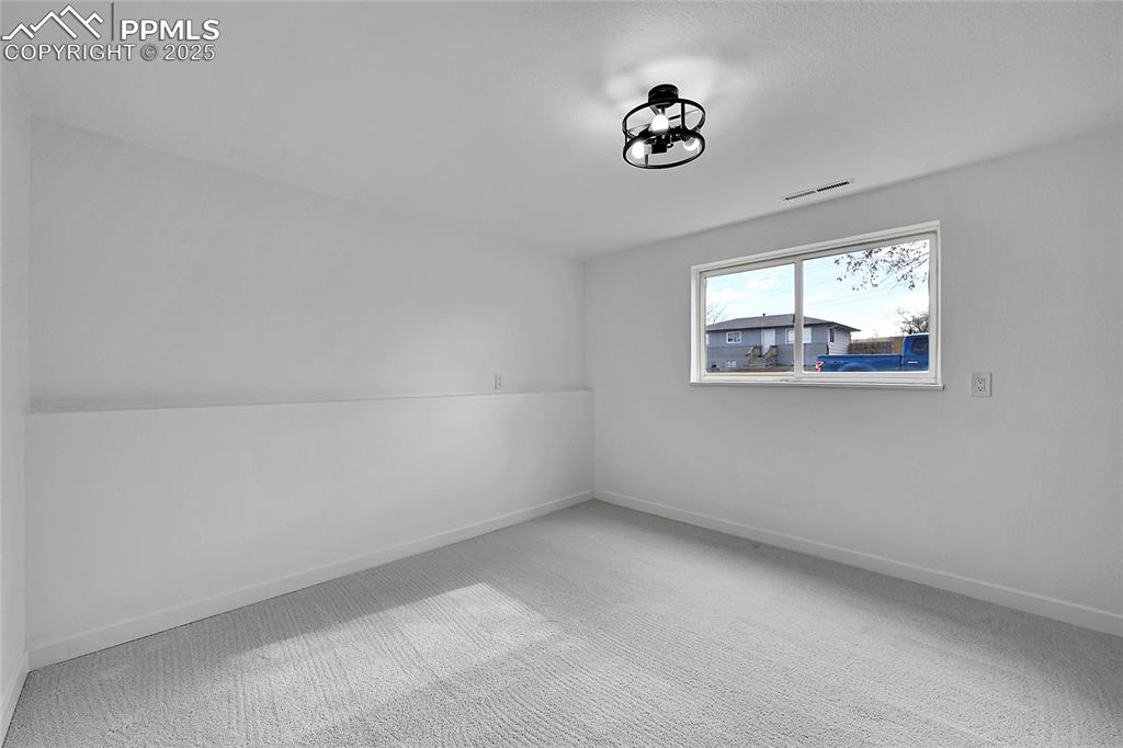 Image 22 of 29: Bonus room with carpet and baseboards