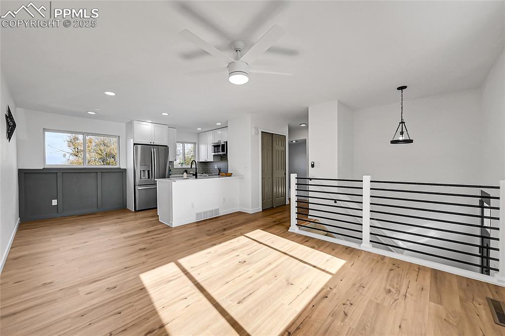 Image 3 of 29: Kitchen featuring recessed lighting, light countertops, ceiling fan, white 