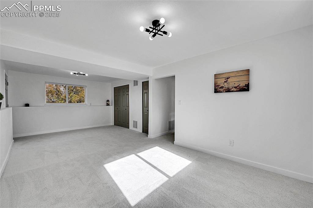 Image 5 of 29: Carpeted empty room with baseboards