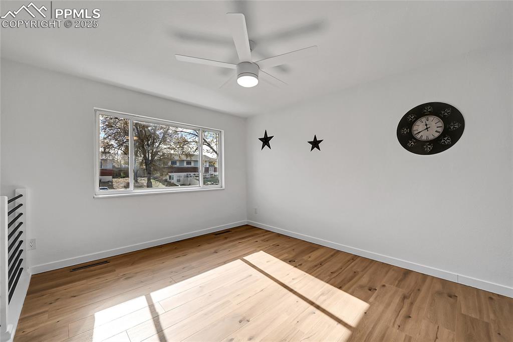 Image 7 of 29: Unfurnished room with light wood-style floors and ceiling fan