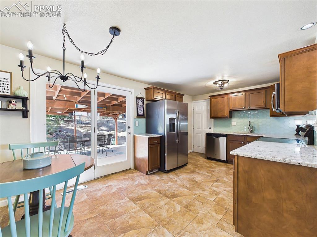 Image 16 of 50: Updated kitchen featuring stainless steel appliances, granite countertops, 