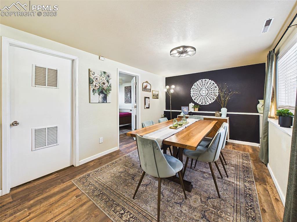 Image 19 of 50: Stylish dining area highlighted by a contemporary sideboard, decorative lig