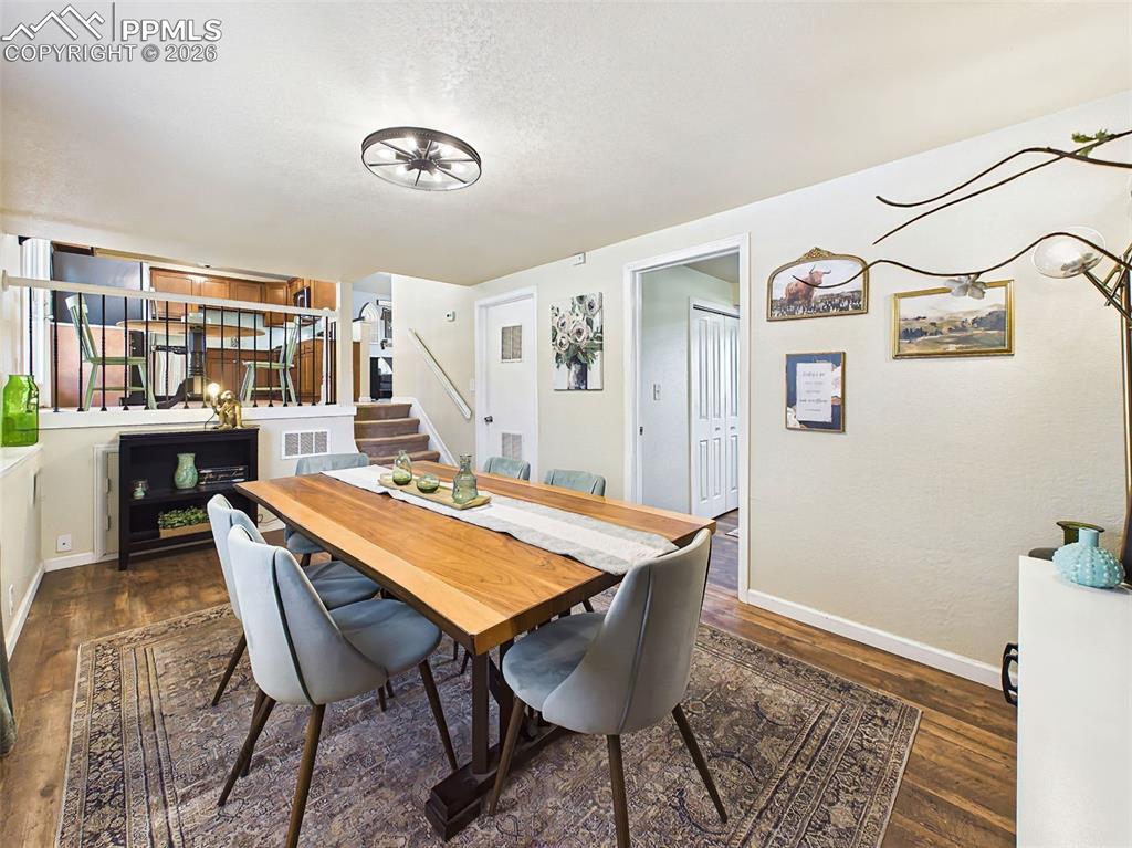 Image 20 of 50: Family Room & Spacious dining space featuring a stylish accent wall, large 