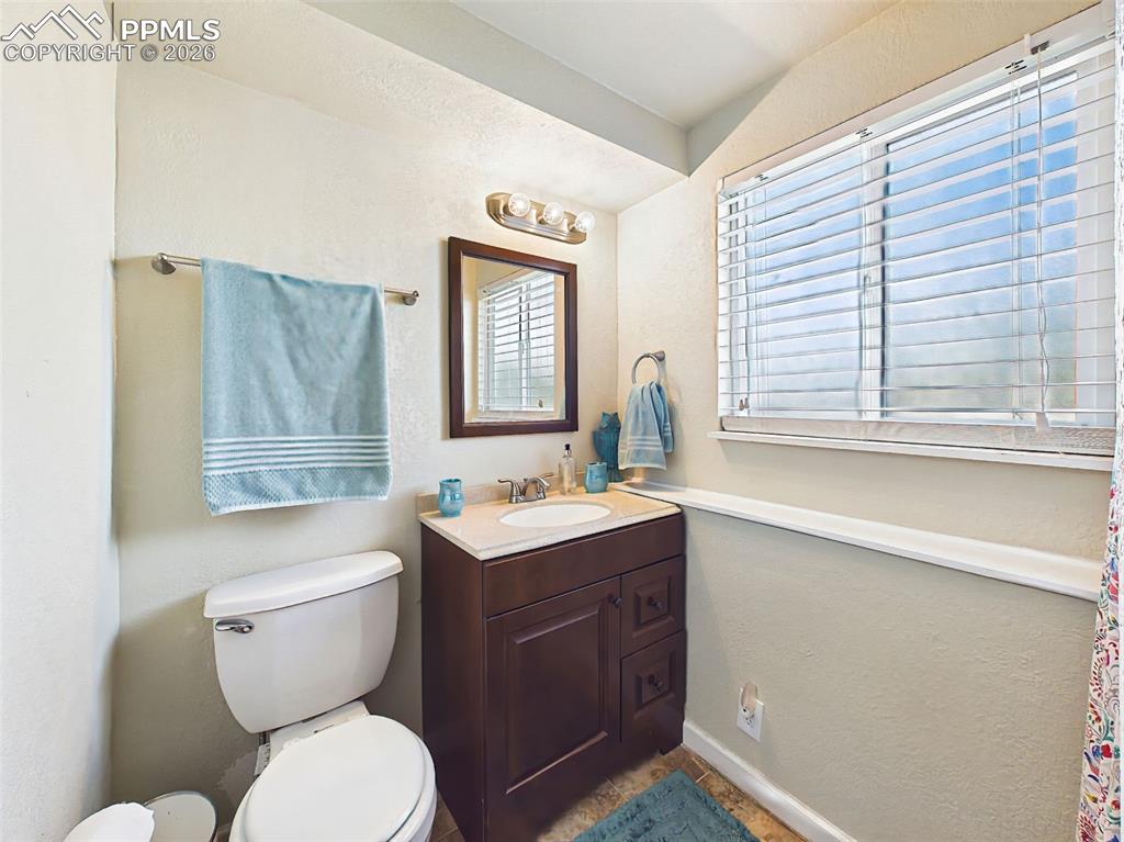 Image 24 of 50: Well-appointed bathroom with updated vanity, modern fixtures, and a window 