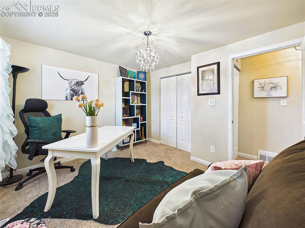 Image 29 of 50: Cozy and functional bedroom or workspace and room for seating or additional