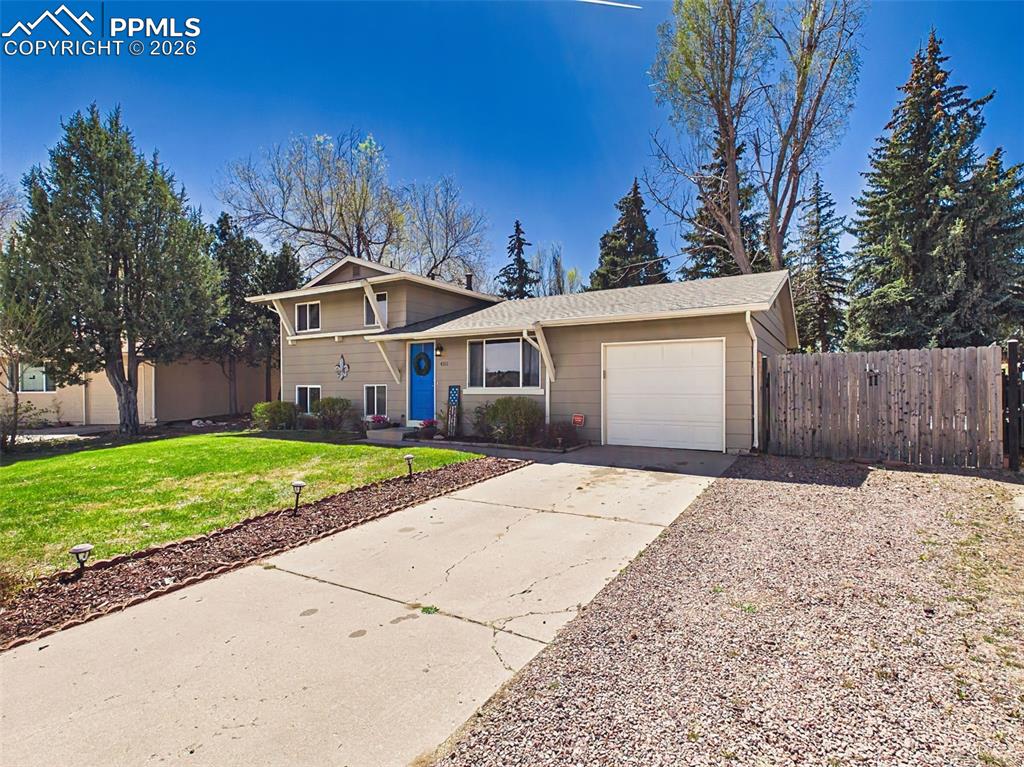 Image 33 of 50: Spacious driveway with attached garage and additional parking area double g