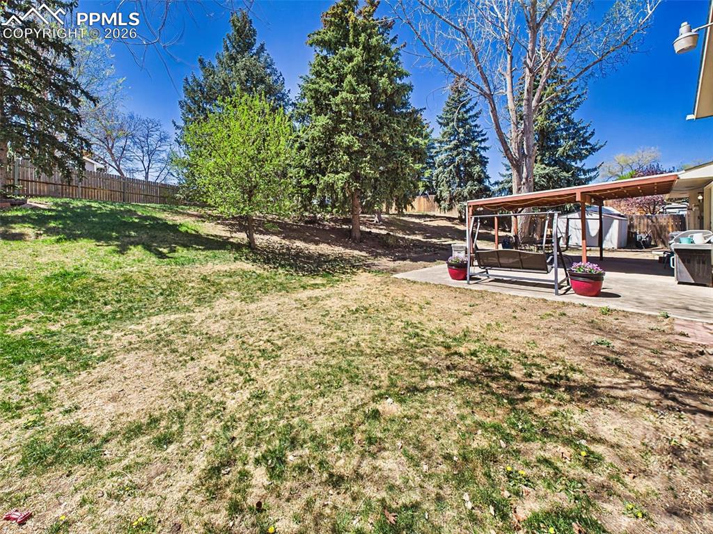 Image 36 of 50: Open yard flowing seamlessly into the patio area, offering an ideal setup f