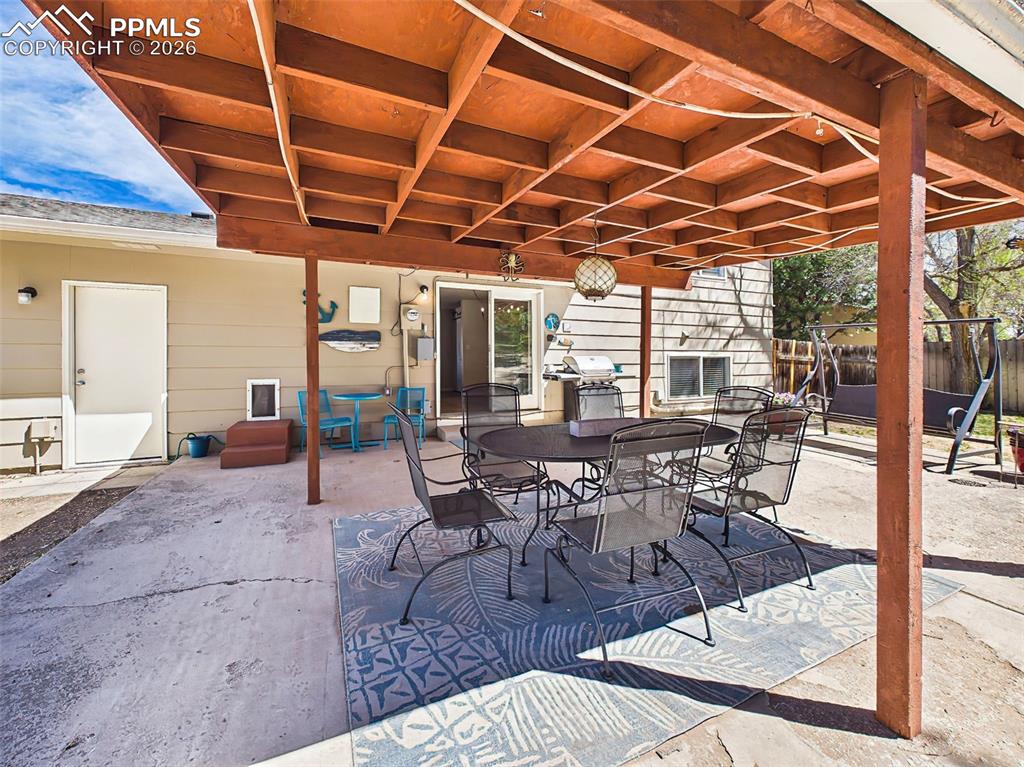 Image 39 of 50: Inviting patio with sun-filtered light and versatile layout, creating a wel