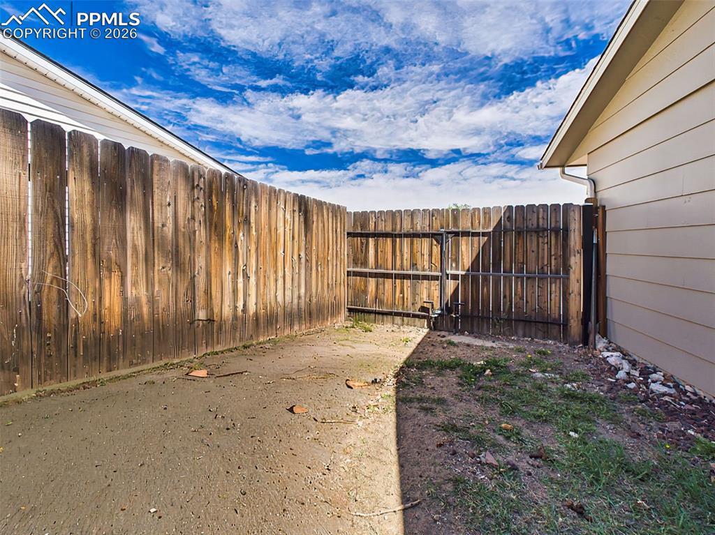 Image 42 of 50: Enclosed side yard with Double gated access, offering possible RV &/or Trai