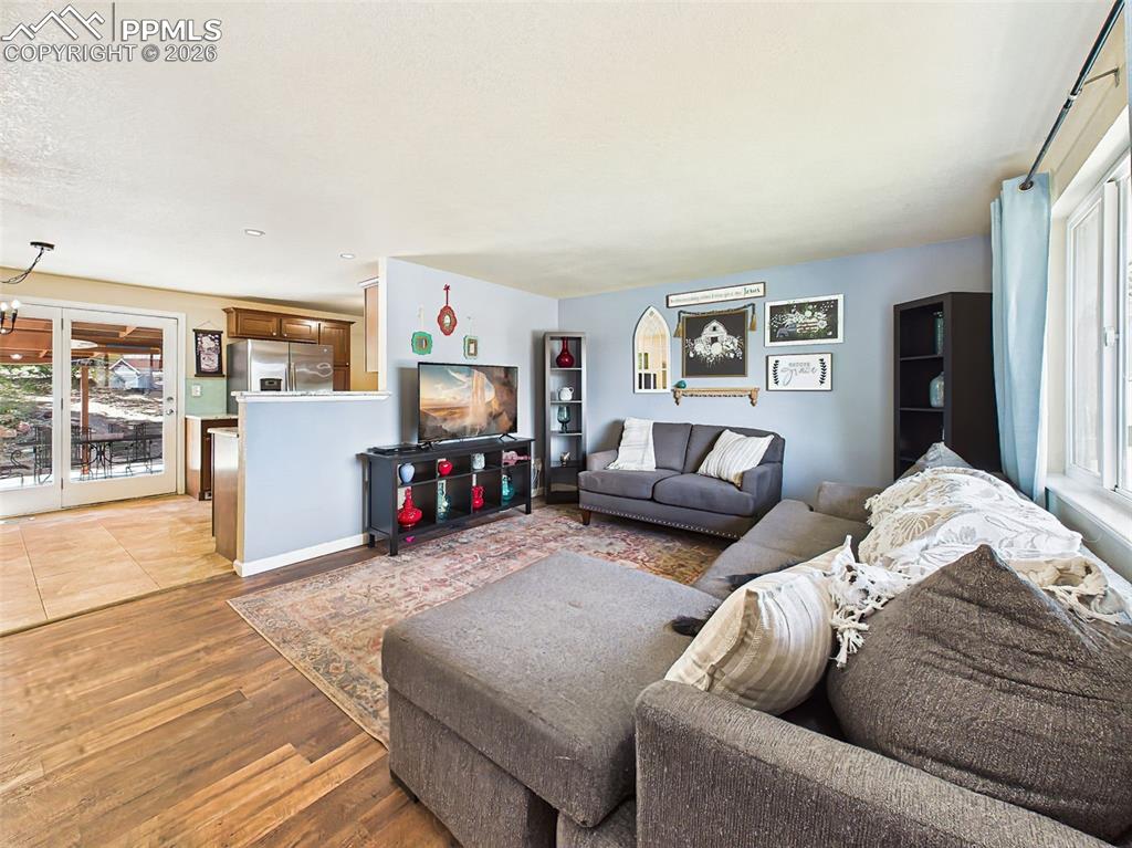 Image 6 of 50: Spacious layout with multiple seating areas, accent wall details, and a wel