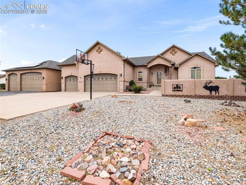 Caption: View of front of home with concrete driveway, an attached garage, and stucco siding