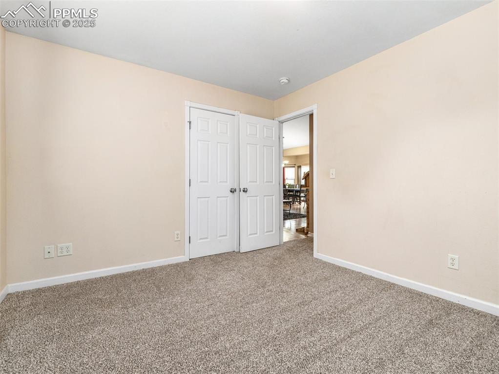 Image 11 of 46: Unfurnished bedroom featuring baseboards and carpet flooring