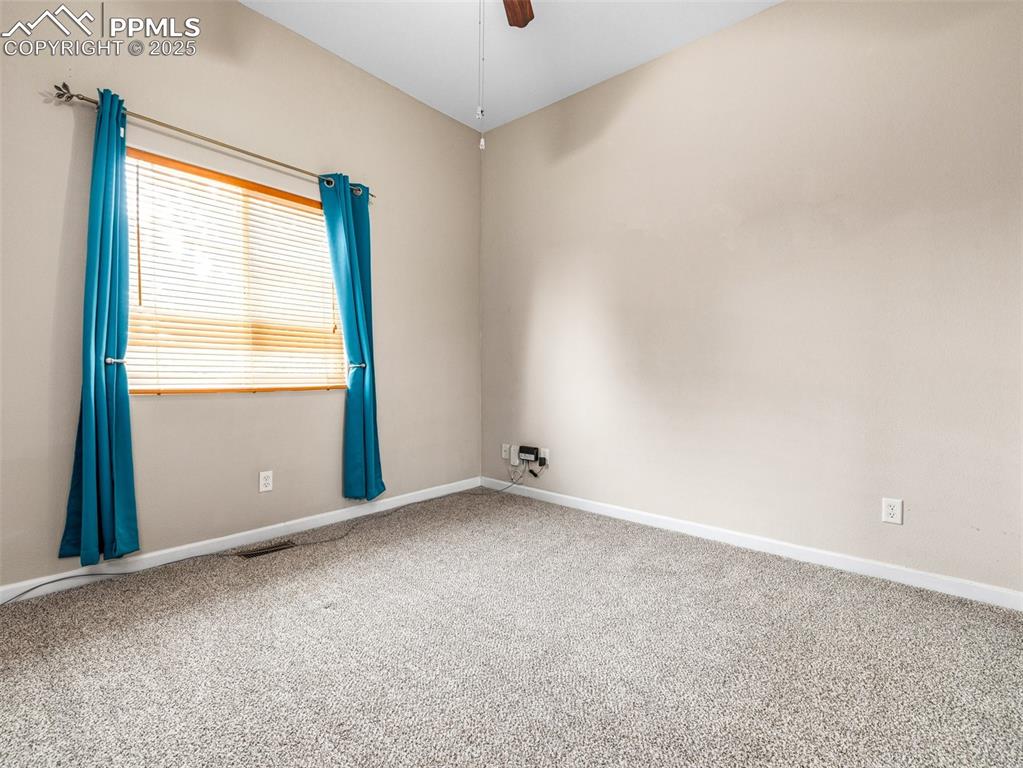 Image 13 of 46: Spare room featuring carpet floors and ceiling fan