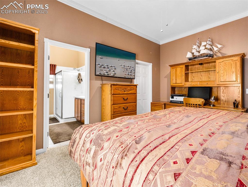 Image 17 of 46: Bedroom featuring crown molding and light carpet